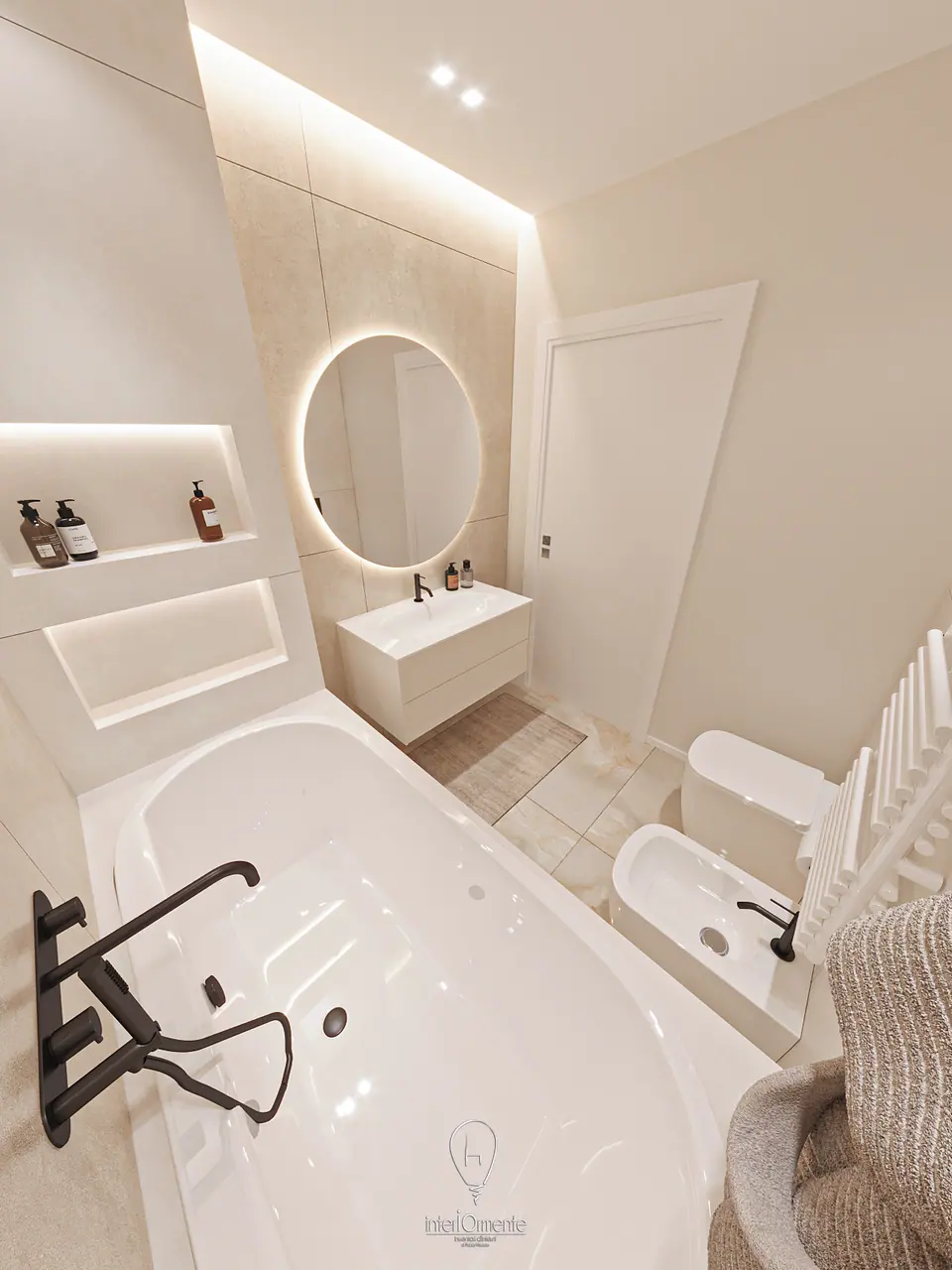 Bagno beige con vasca a incasso, specchio tondo retroilluminato e sanitari sospesi