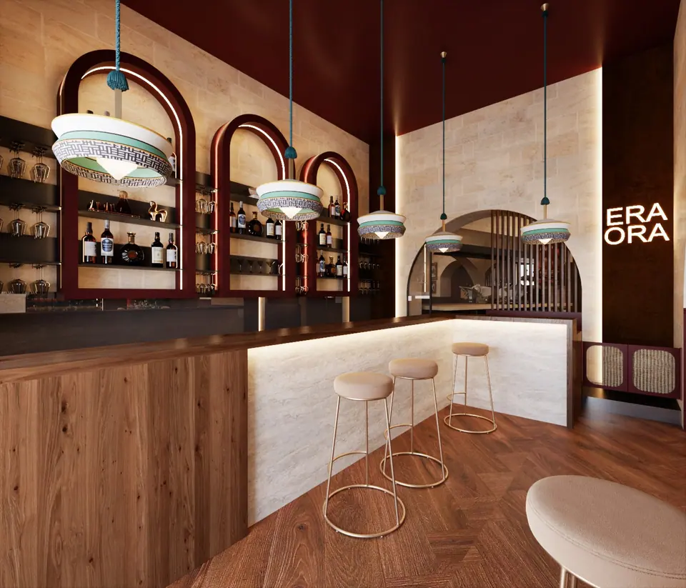 Bar con arcate retroilluminate, bancone in marmo e sgabelli dorati