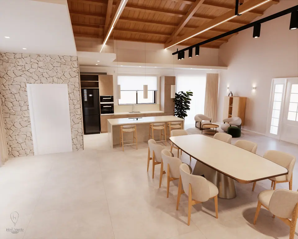 Cucina open space con travi a vista, isola in pietra e tavolo integrato